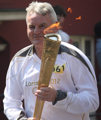 Swindon schoolteacher Iain Perkins carrying the torch down the High Street (pic Virginia Young)