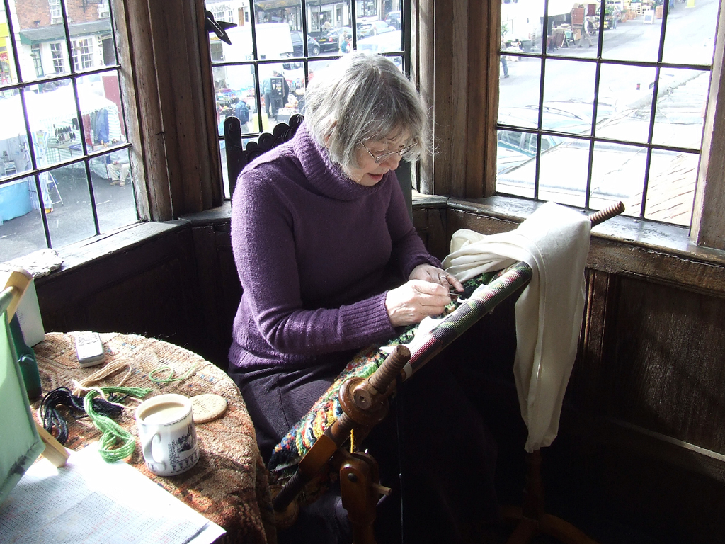 A volunteer recreates a chair cover