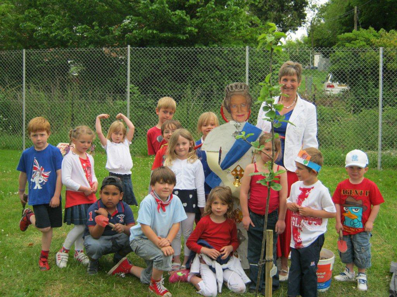 Children from St Mary's Infants celebrating the Queen's Diamond Jubilee by planting an apple tree as part of the Community Orchard project