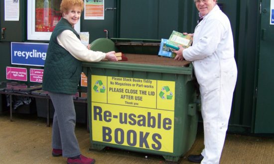 Bookworms Juniper Bracey and Alexander Kirk Wilson making use of the book collection container at Marlborough's household recycling centre