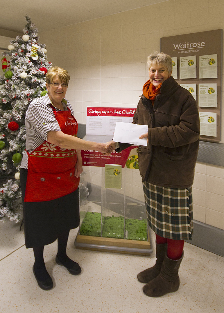 Janice Kingstone, Waitrose's community matters organiser, hands over cheque to Carole Walker of the Jubilee Centre