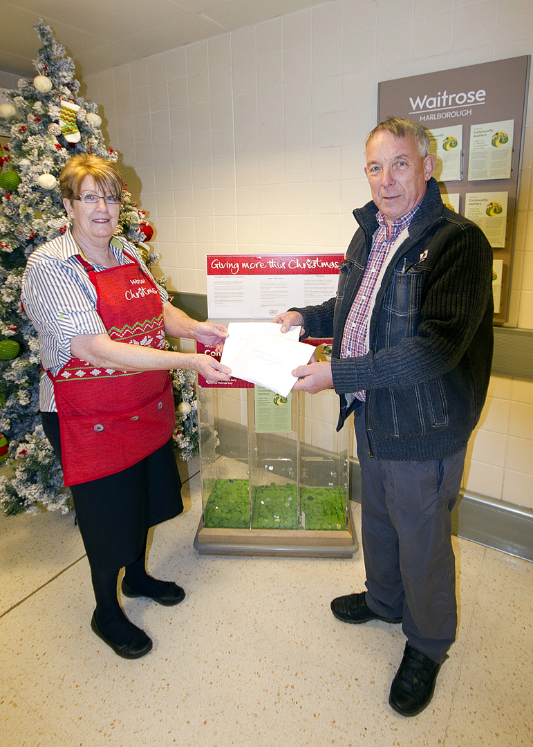 Janice presents Waitrose tokens to Nigel Kearton, organiser of the Over 60's Christmas lunch event