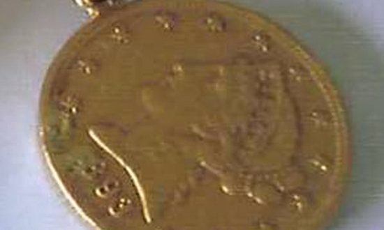 American gold sovereign on a gold chain, with the year 1893 inscribed upon it - patt of the stolen hoard