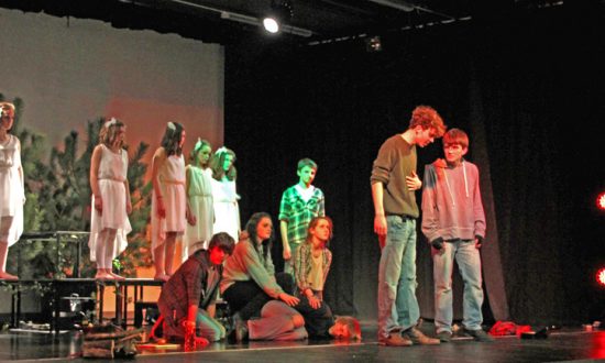 Front of stage: Tristan (Christopher Baker) talks with Jack (Edd France) in front of gang members & watched over by the Light Angels