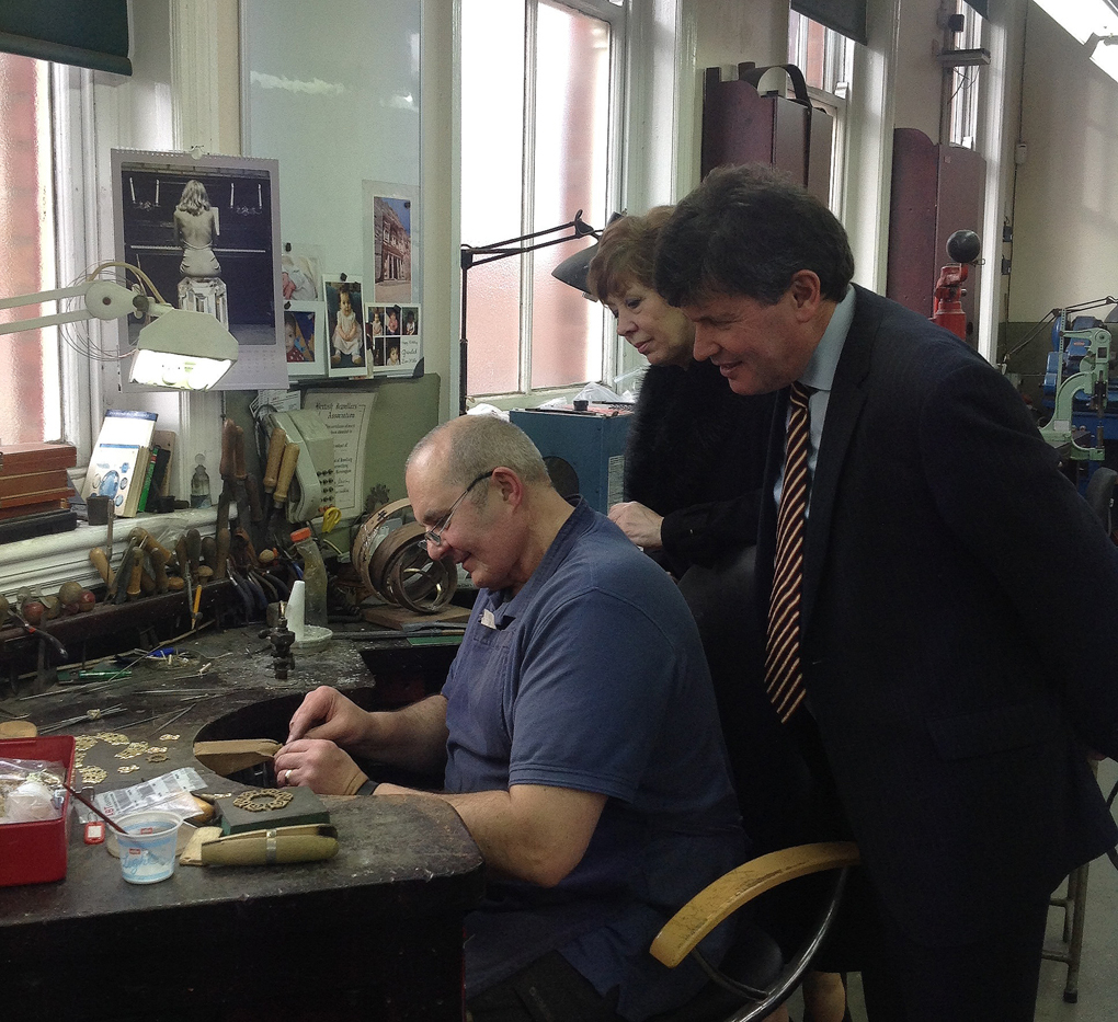 Mayor Councillor Guy Loosmore and Deputy Mayor Councillor Marian Hannaford-Dobson watch a craftsman in action