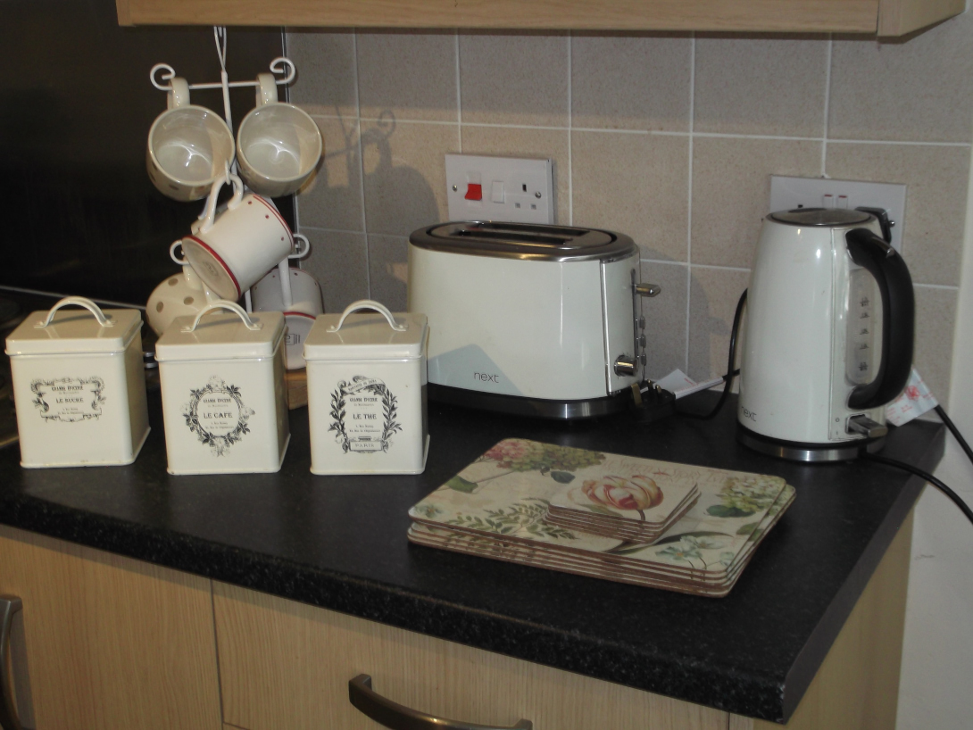 Various kitchen items, Breville toaster, electric kettle, storage tins, place mats, mugs and rack