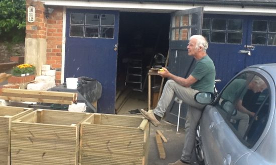 Mike Salmon taking a quick break from constructing the planters to be sited across the village