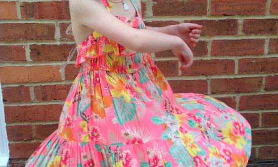 Junior model Matilda displays one of Monsoon's themed dresses