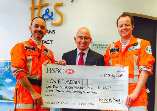 Jonathan Glover and Dan Bawden receive the cheque from Malcolm Lee manager at Haine Smiths Marlborough branch