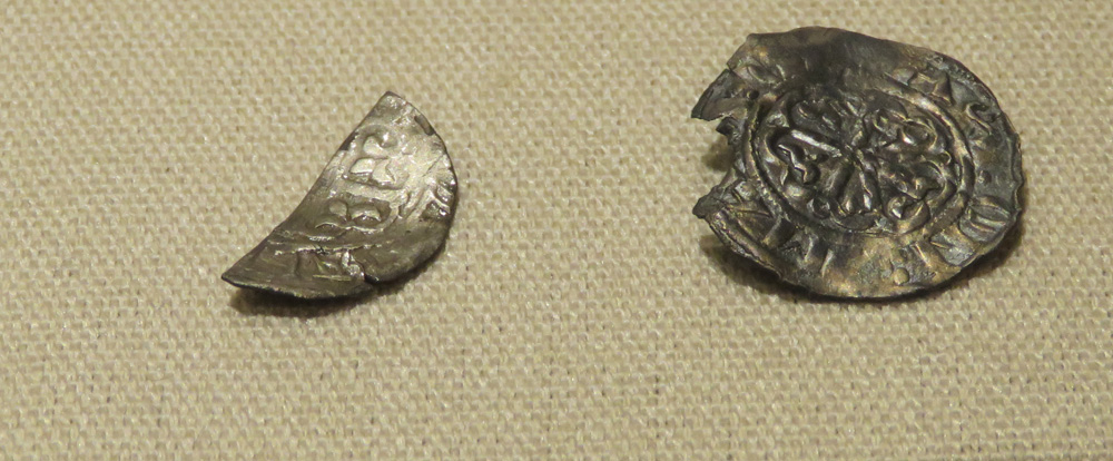 The cut halfpenny minted in Marlborough is on the left