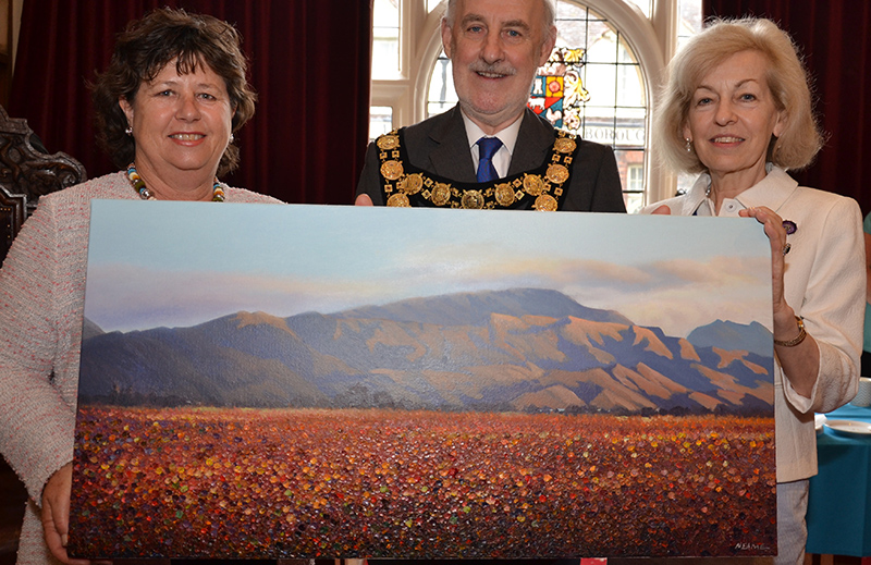 Councillor Cynthia Brooks presents Autumn Twilight in Marlborough to mayor and mayoress Noel and Susan Barrett Morton