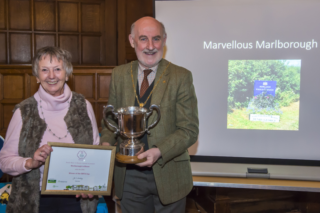 Mayor Cllr Noel Barrett-Morton presenting Chair Anne Crawley with the South West Tourism Association Cup
