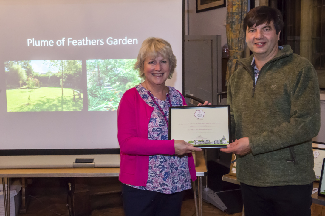 Richard Beale presenting Susan Rosa of The Plume of Feathers Garden with their Advancing 'In Your Neighbourhood' award