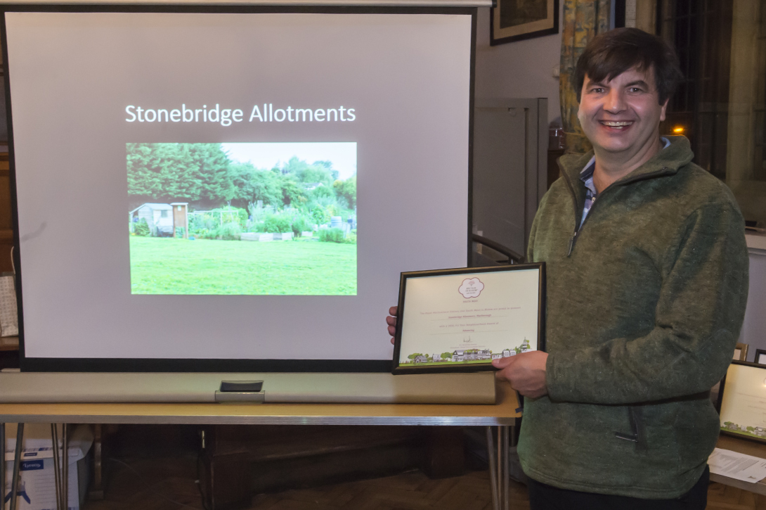Richard Beale presenting himself with the Advancing 'In Your Neighbourhood' award for the Stonebridge Allotments