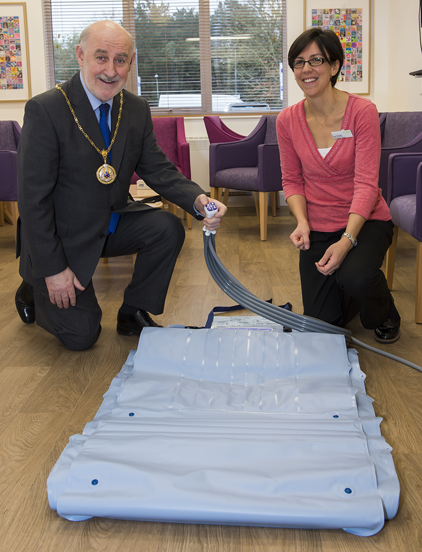 Mayor Cllr Noel Barrett-Morton inflating the new lifting cushion with assistance from Zoe O'Reilly, Outreach Centre Co-ordinator for Prospect Hospice at Savernake Hospital