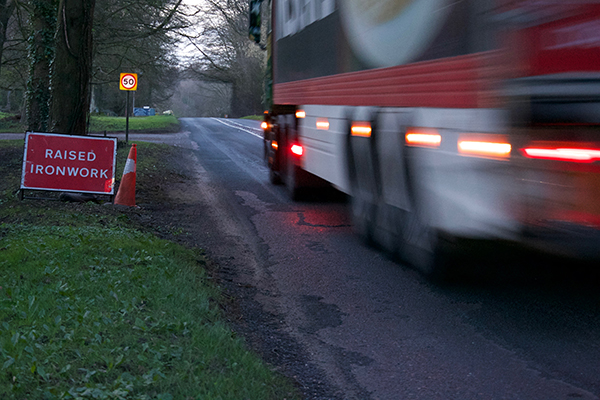 A lorry passes along the A346 at Cadley where the road surface is badly worn