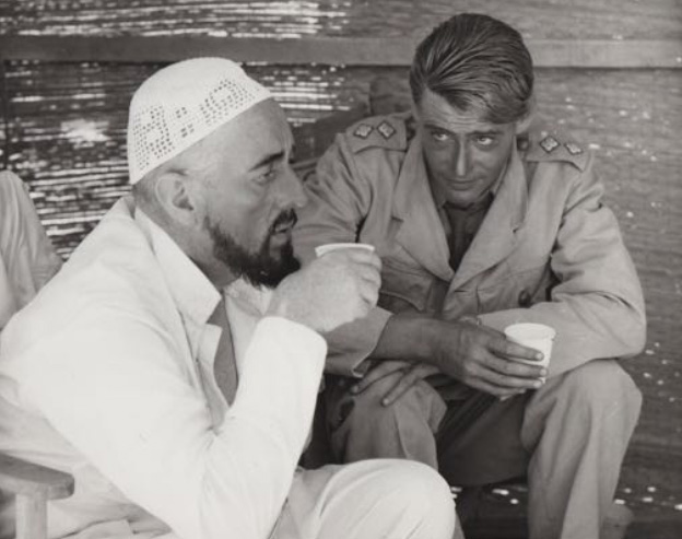 Photo by Ken Danvers (1911-1980): Peter O’Toole with Alec Guinness on the set of ‘Lawrence of Arabia.’ (1961/62) Original vintage photograph. Production stamps on the back signed by Danvers - David Lean’s regular stills photographer
