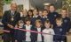 Mayor Councillor Mervyn Hall, accompanied by Year 6 pupils with their reception buddies and head teacher Claire Graham cuts the ribbon to declare the new Library open