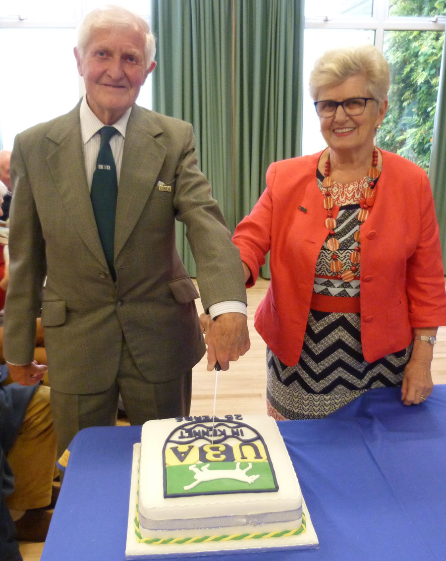 Derek Robbins and Pam Jones cutting the cake