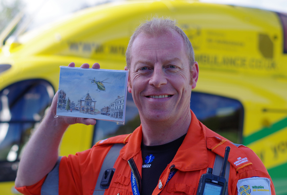 Wiltshire Air Ambulance Paramedic Keith Mills with the 'Christmas in Marlborough' card