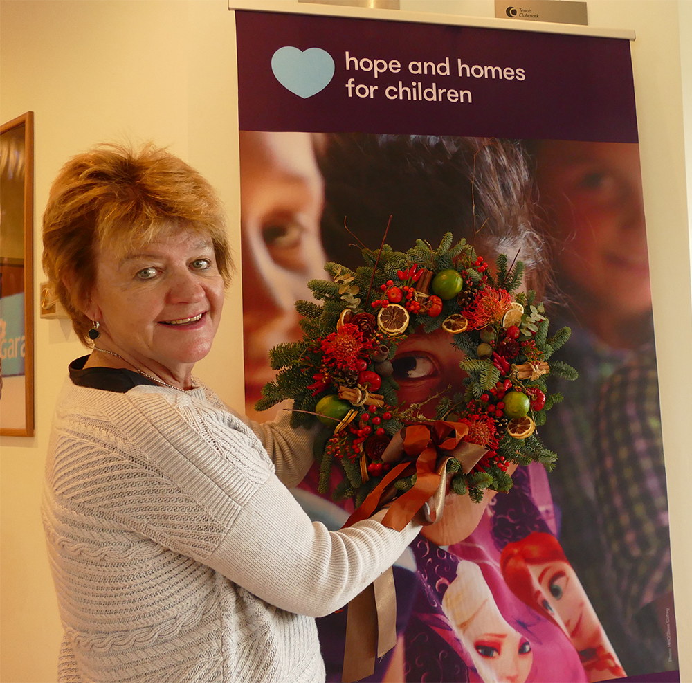 Ann Swift displaying 'one I made earlier' Christmas wreath