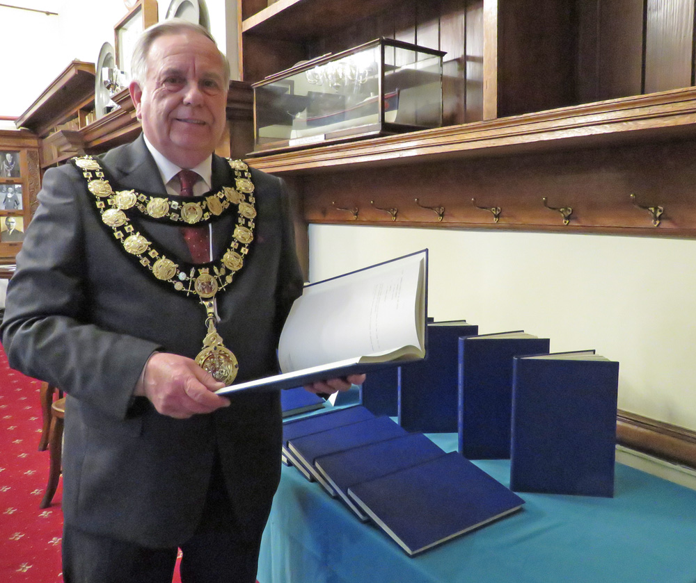 Town Mayor Councillor Mervyn Hall with some of the bound volumes of minutes