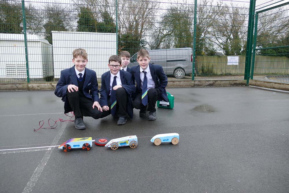 Year 7 students with the cars they made