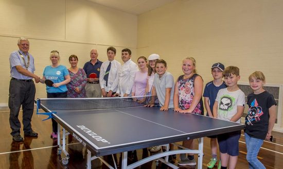 Mayor Lisa Farrell accompanied by Youth Centre colleague XXX accepts the new Table Tennis Table from Marlborough Rotary President Cedric Hollingsworth and Martin Luxford along with some of the Youth Centre's regular attendees