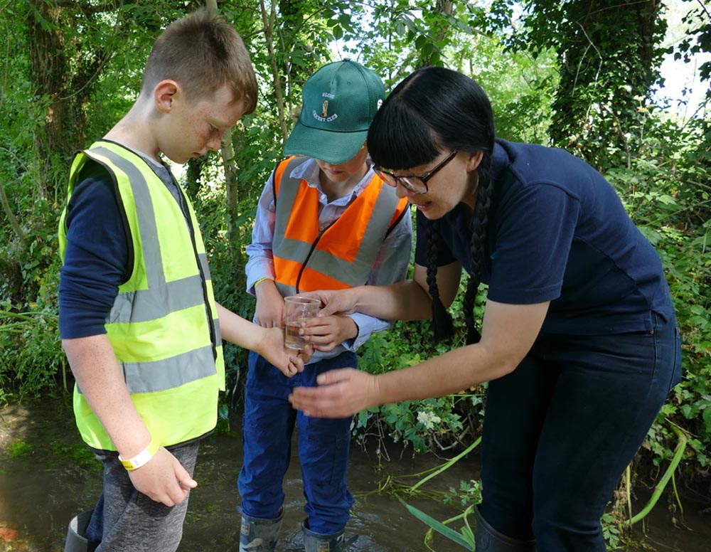 Preshute pupils with Anna Forbes get ready to release their eel