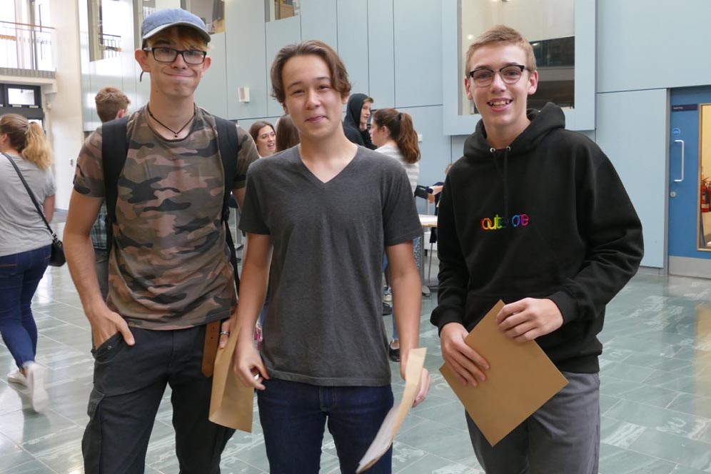 Pleased as punch - St John's students Chey Davies, Reece Davidson and Ryan Hill with their GCSE result envelopes