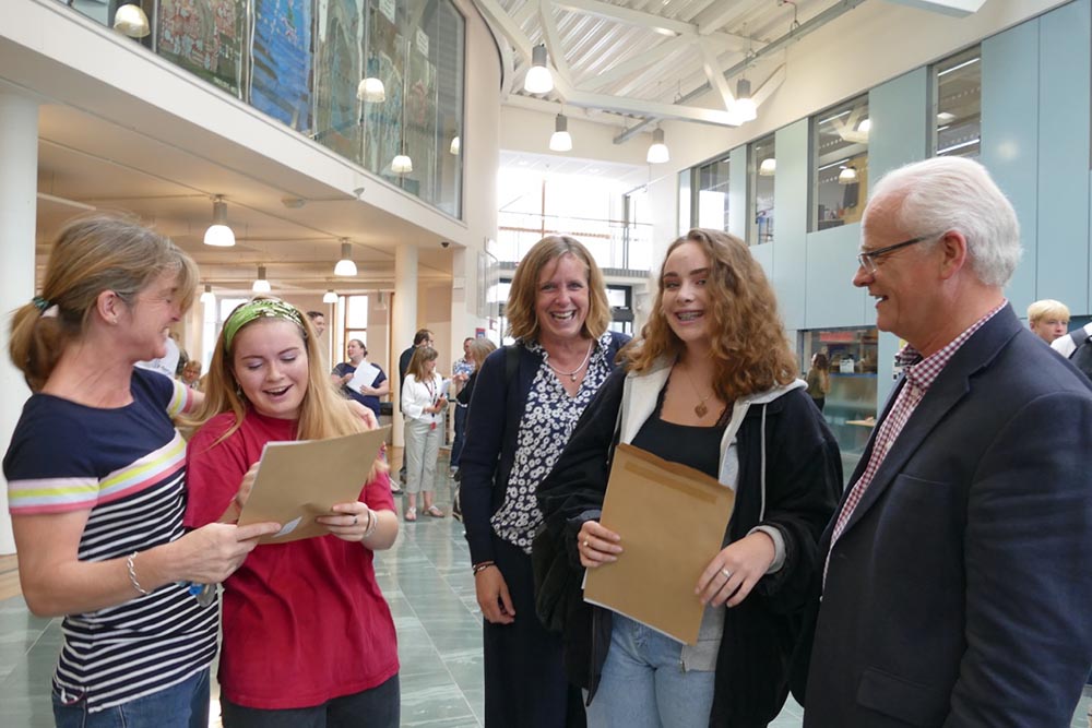 St John's students Tess Mayer left and Alice Compton right open their GCSE results watched by their parents