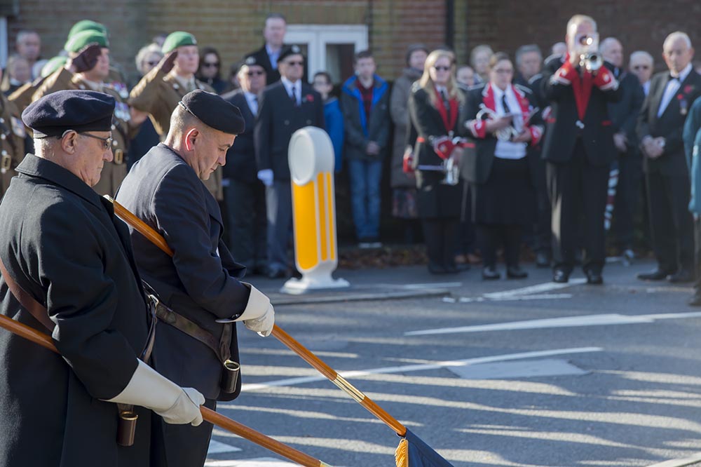 The Last Post rings out as Colours are lowered during the Remembrance Parade at the Barn Street War Memorial