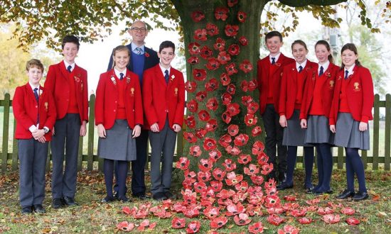Headmaster David Sibson with St Francis pupils and the ceramic poppies they made