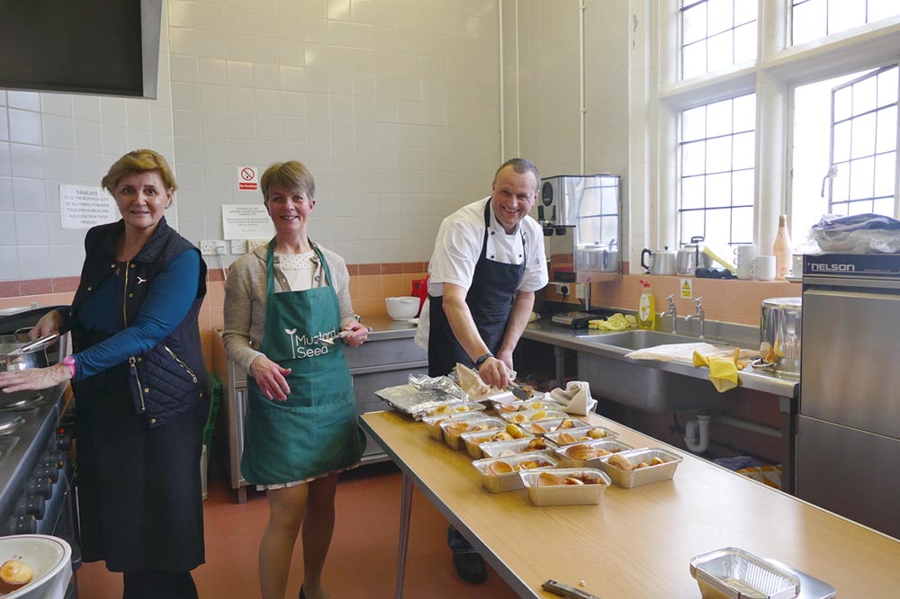 Mark Shire, chef with volunteers in the kitchen