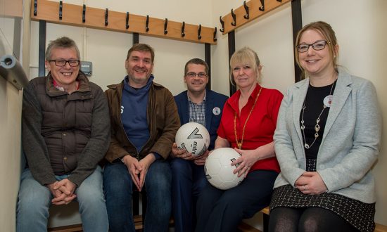 Mayor Lisa Farrell (2nd from right), Marlborough Tesco manager Matt Jones (also holding a football) with colleague Jo Bayliffe check out the newly equipped changing rooms for size with MYFC's John Evans (vice chair - left) and Stuart Slater (chair)