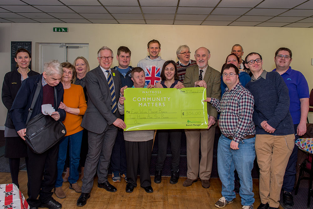 Cllr Noel Barrett-Morton accepts the large green cheque on behalf of the group from Marlborough Waitrose manager, Ian Burdekin and Community Champion, Lisa Wakeham