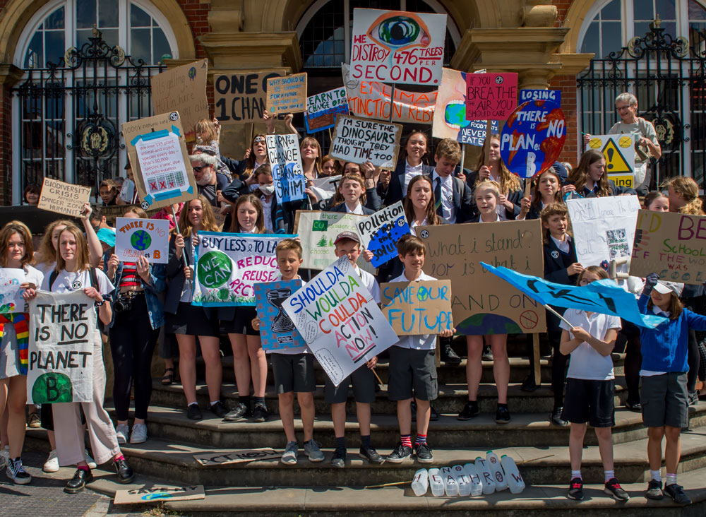 Young protesters chant their demands from the steps of the Town Hall