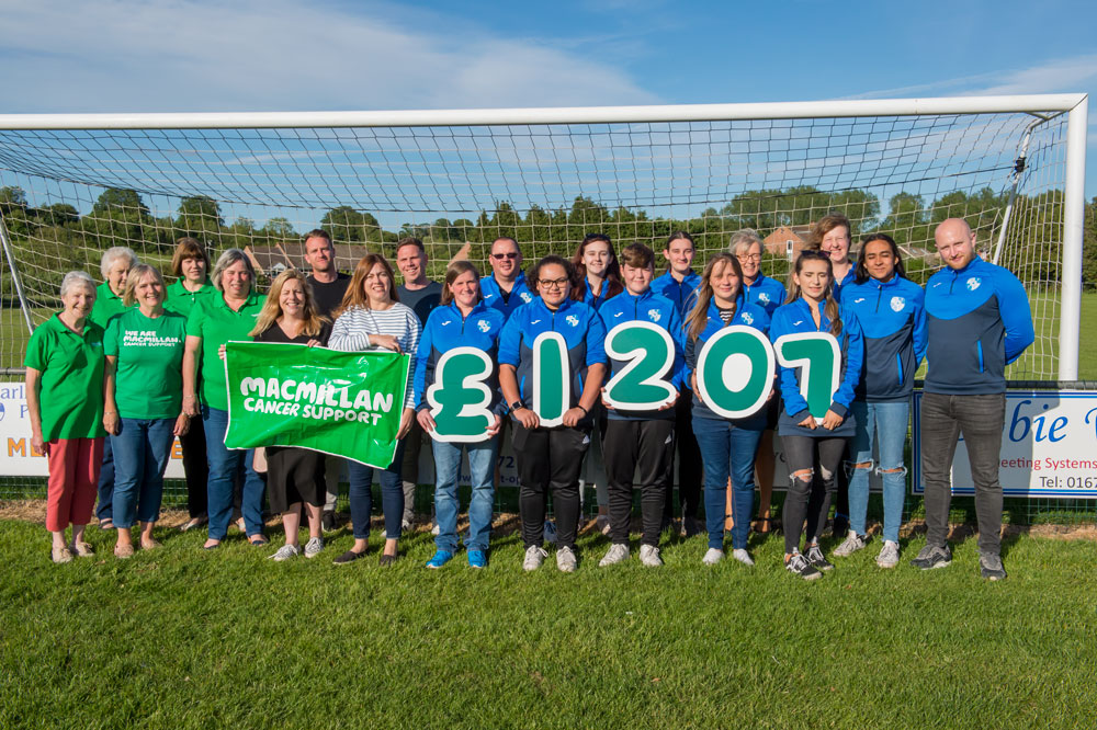 Macmillan Marlborough representatives Rose Martin, Kirsty Martin, Sandra Bull, Janet Buck and Vanessa Hillier (in green T-shirts) together with members of the current Ladies and Veterans teams celebrate the success of the recent charity fundraiser match showing clearly how much was raised