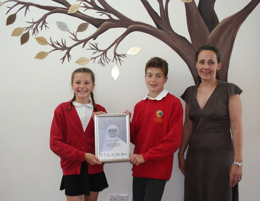 Rachel Haines, PE Subject Leader at Marlborough St Mary's and pupils with the School Games Silver Award
