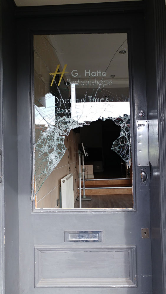 Smashed glass door at G Hatto barbers in the High Street 