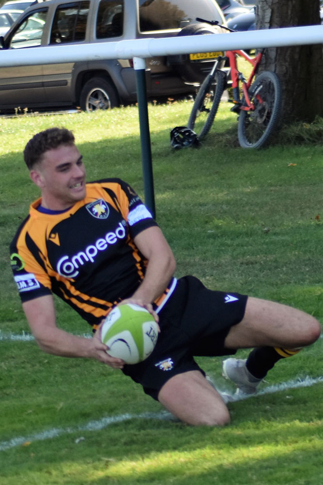 Callum Hunt goes over to score