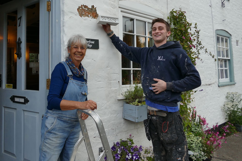 Val Compton with Kye Carty Barrett installing the bee brick