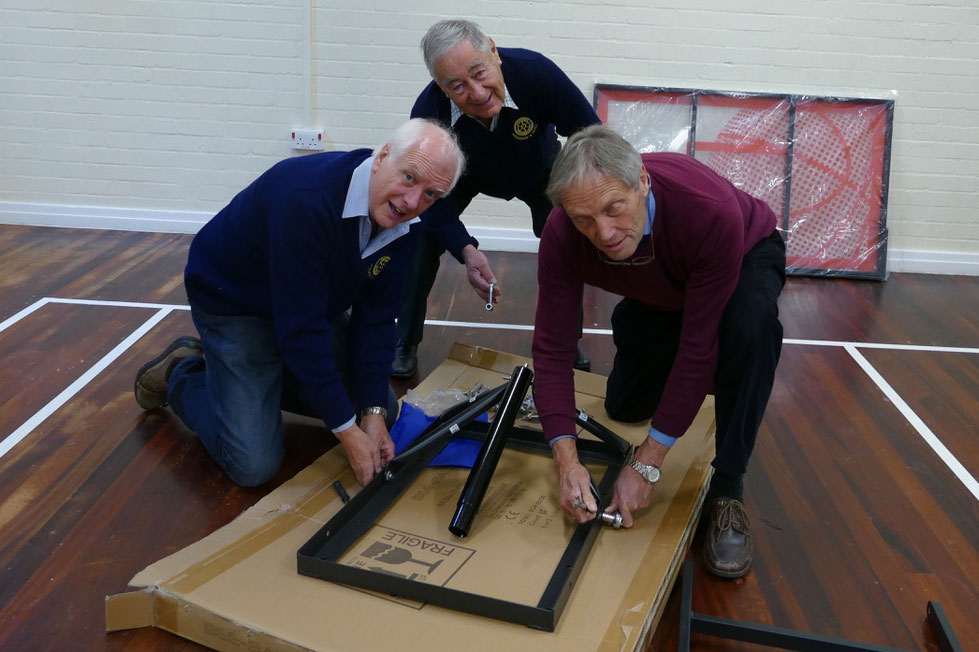 Martin Luxford, President of Marlborough and District Rotary with Jerry Hooper and Paul Cowan assemble the basket ball backboards