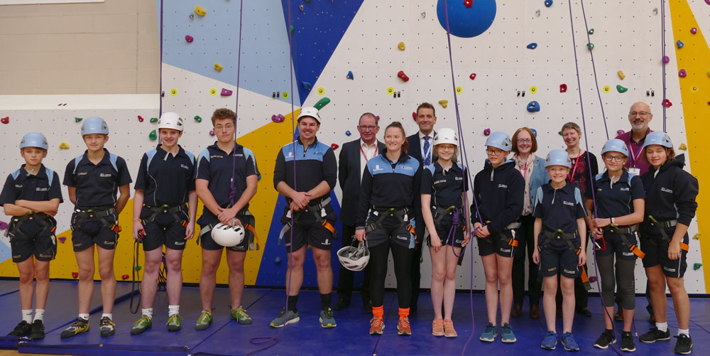 Students ready to sample the delights of the new St John's Academy climbing wall with Headteacher Ian Tucker'second row, second from L, members of the St John's Foundation Trust and PE Staff