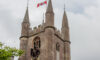 Removing the Clock Face from st Peter's Church Marlborough with the National Flag of Canada flying in honour of Canada Day 2021
