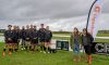 Michelle Tanfield and Rezia Khan, Community Engagement Managers from Gigaclear with members of the Marlborough 1stXV beside the new Gigaclear sponsored digital scoreboard